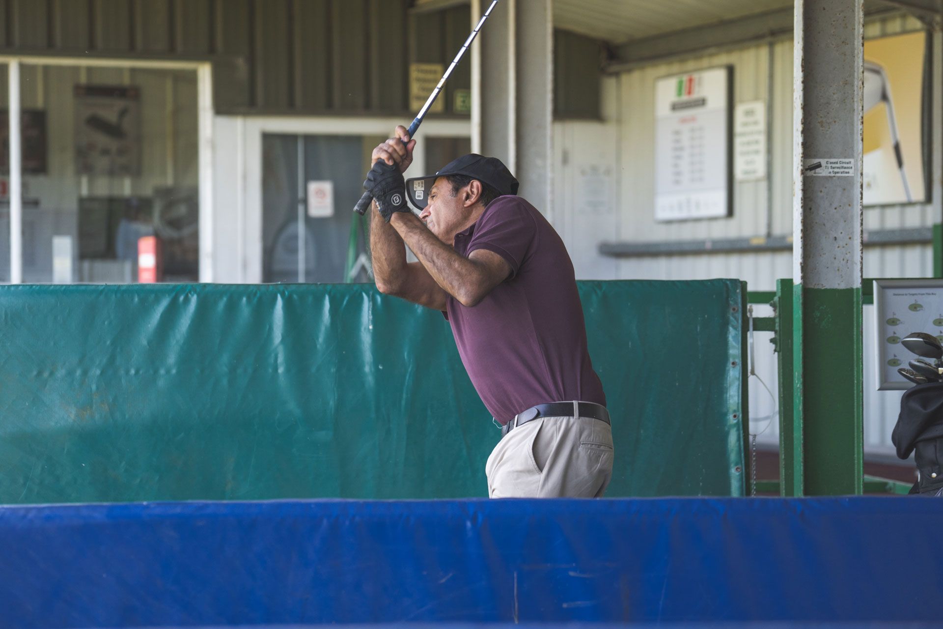 Golfer mid-swing on the range
